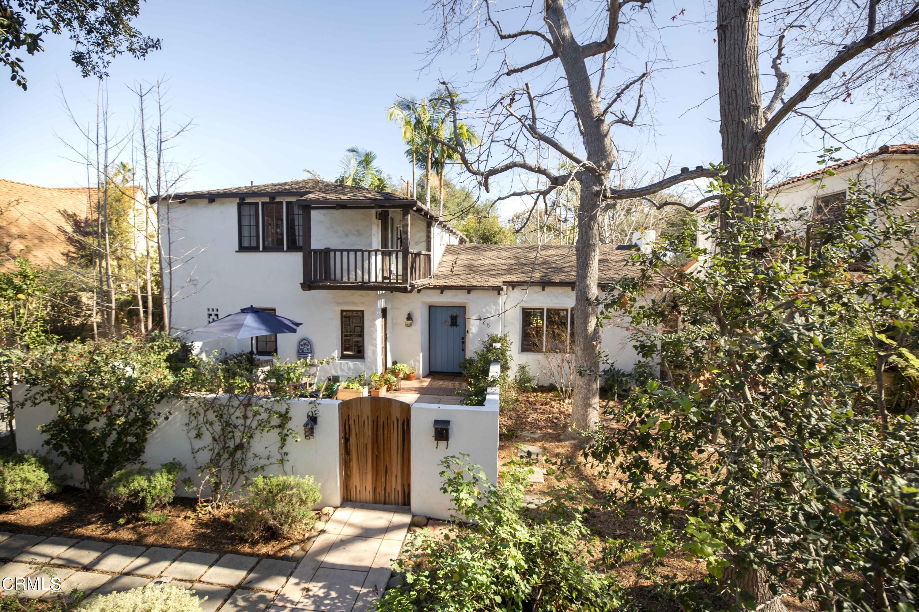 a view of a house with yard and sitting area