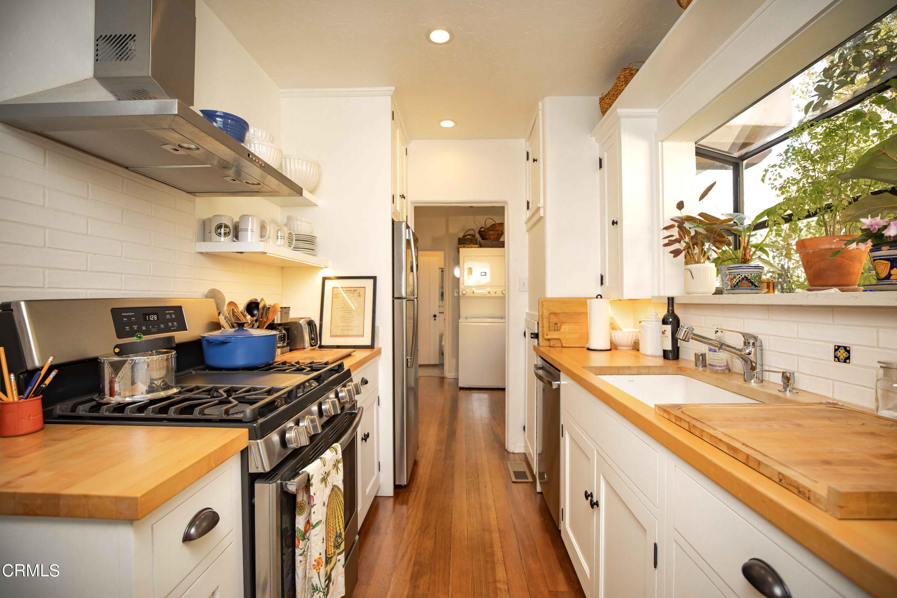 426 South Berkeley Avenue Pasadena, CA 91107 - Photo 11 of 32 a kitchen with stainless steel appliances granite countertop a sink stove and refrigerator