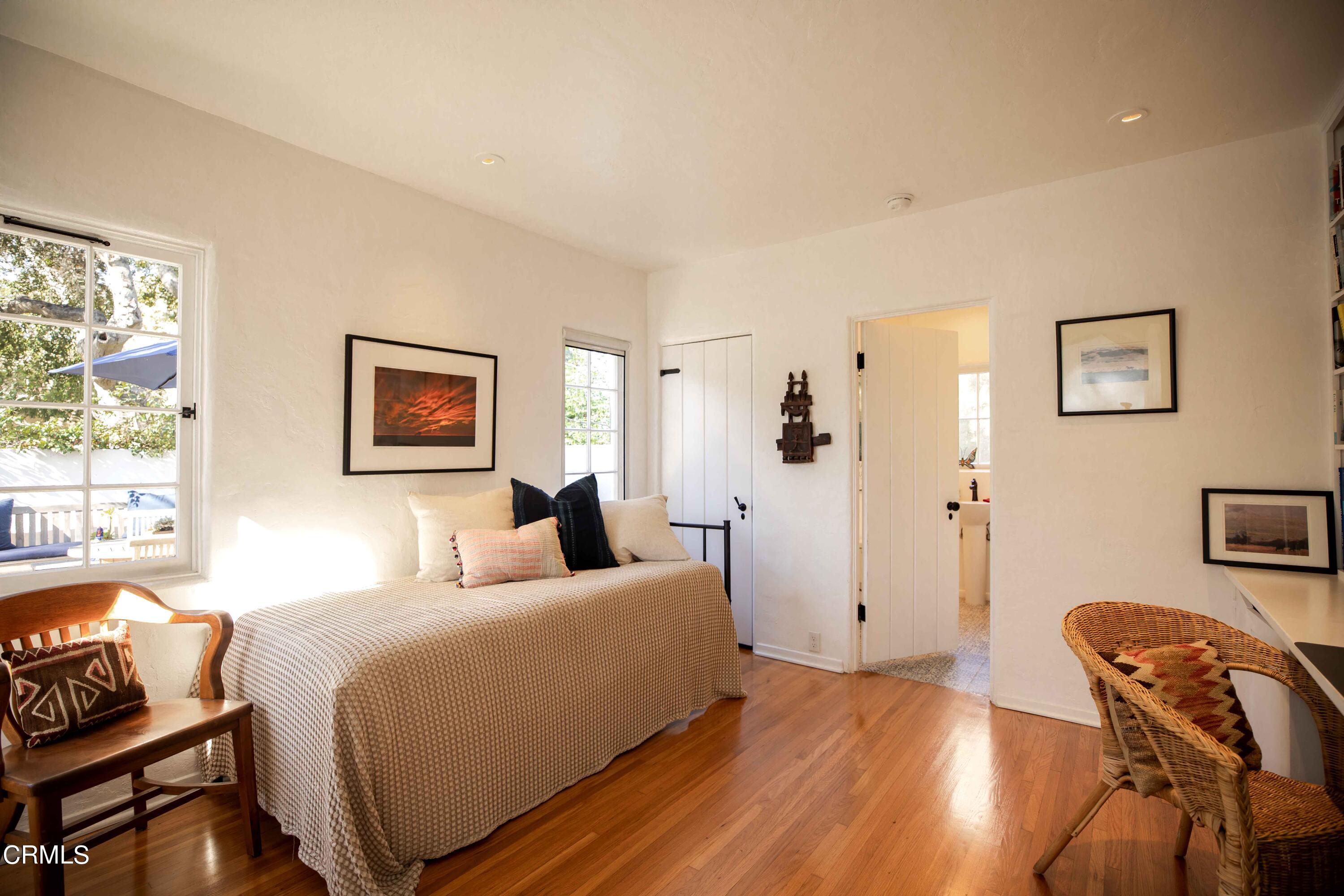 426 South Berkeley Avenue Pasadena, CA 91107 - Photo 13 of 32 a bedroom with a bed and wooden floor