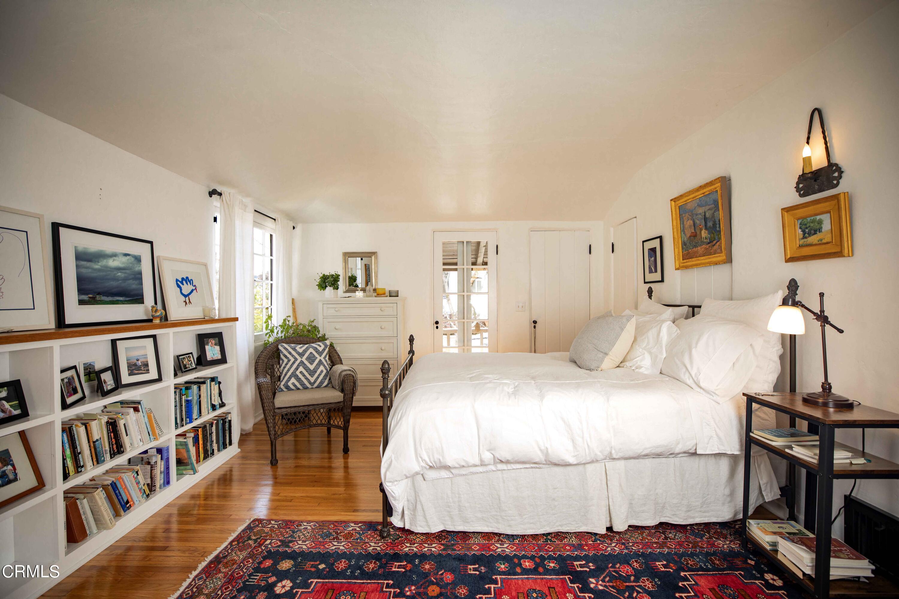 426 South Berkeley Avenue Pasadena, CA 91107 - Photo 17 of 32 a spacious bedroom with a bed a dresser and book shelf