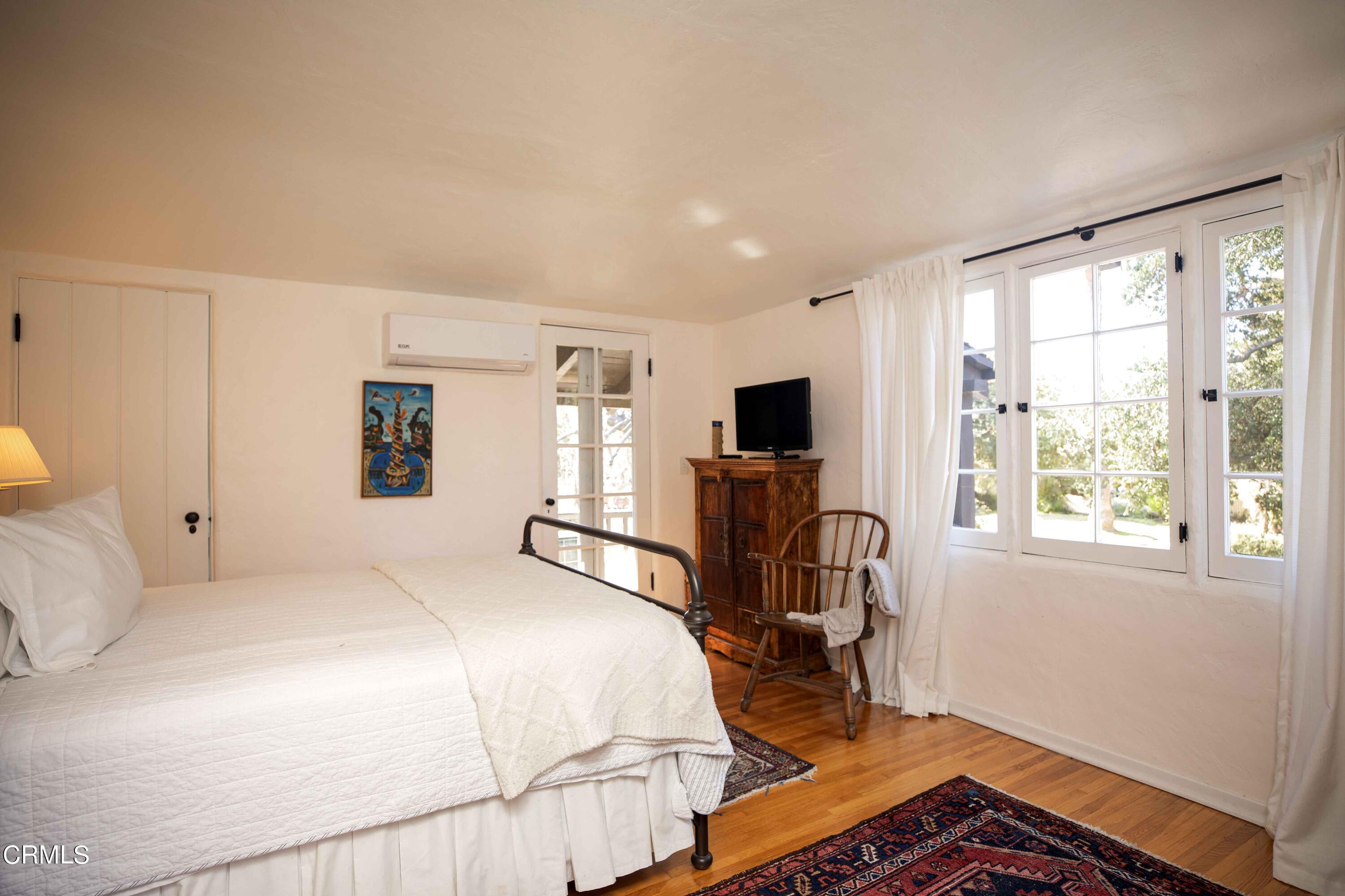 426 South Berkeley Avenue Pasadena, CA 91107 - Photo 19 of 32 a bedroom with a bed chair and window