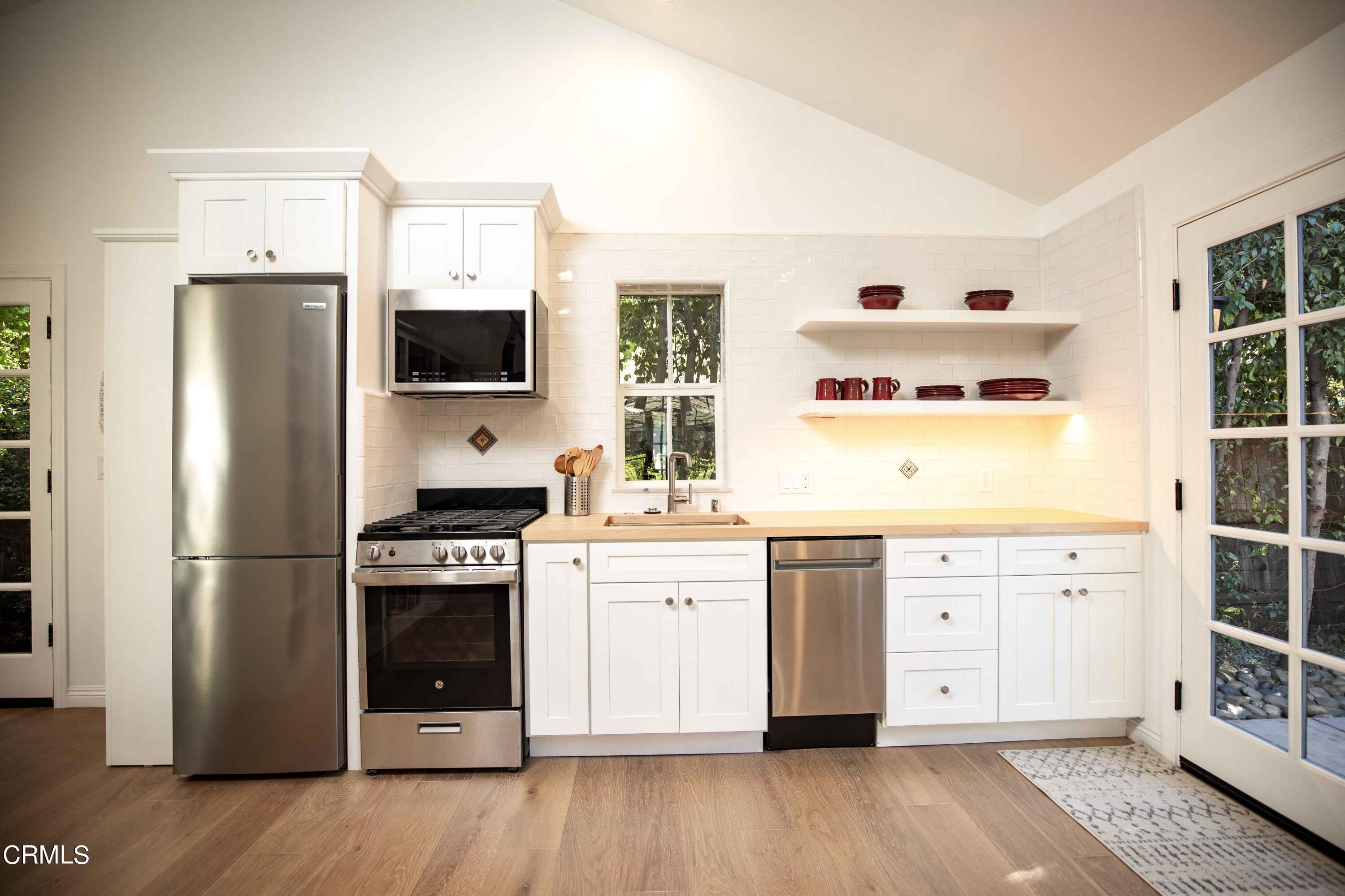 426 South Berkeley Avenue Pasadena, CA 91107 - Photo 26 of 32 a kitchen with stainless steel appliances a stove a refrigerator and a window