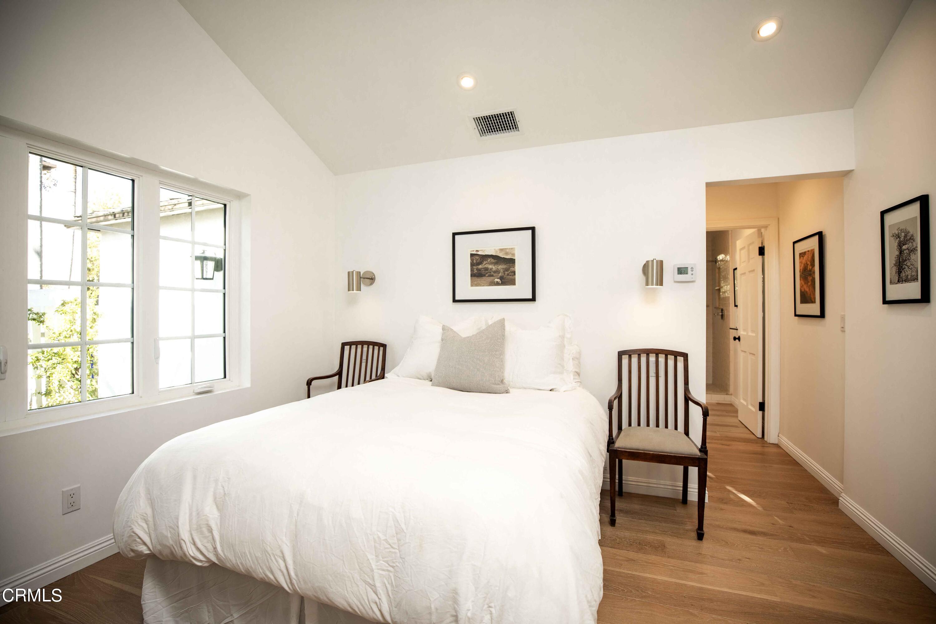 426 South Berkeley Avenue Pasadena, CA 91107 - Photo 27 of 32 a bedroom with a bed and a chair