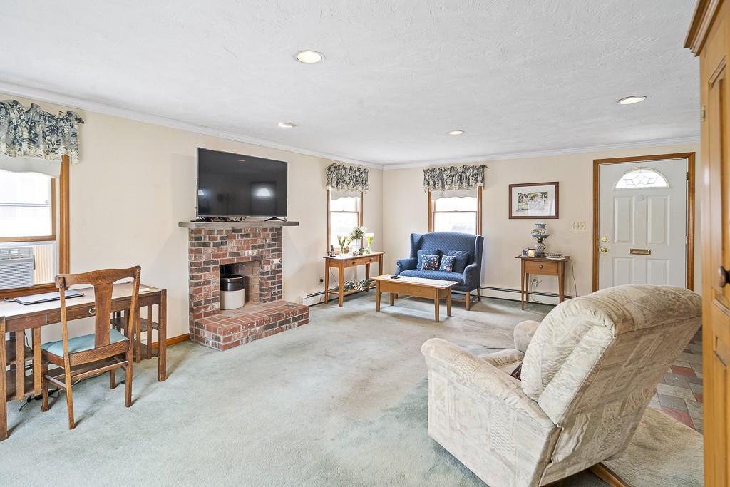 105 Sheffield Road Waltham, MA 02451 - Photo 11 of 22 a living room with furniture a flat screen tv and a fireplace