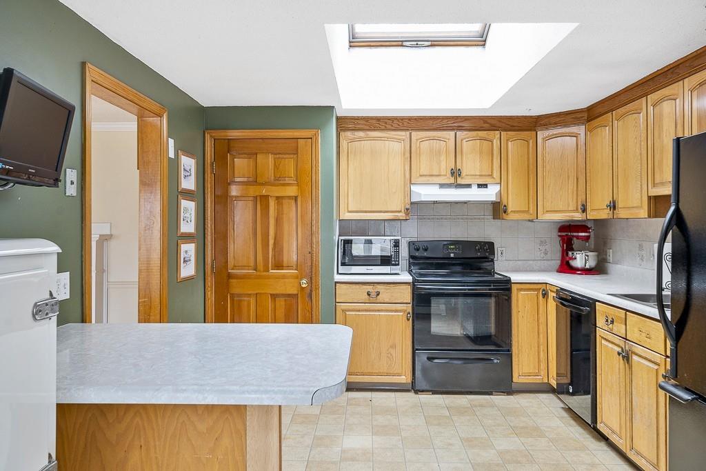 105 Sheffield Road Waltham, MA 02451 - Photo 4 of 22 a kitchen with stainless steel appliances granite countertop a stove a sink and a refrigerator