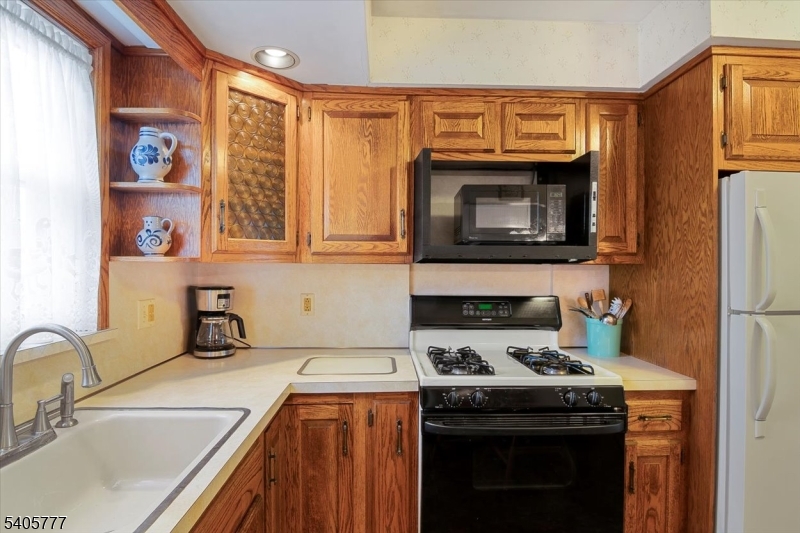 735 Garden Street Union, NJ 07083 - Photo 12 of 29 a kitchen with stainless steel appliances a stove a sink and a microwave