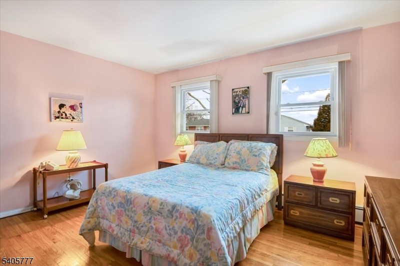 735 Garden Street Union, NJ 07083 - Photo 13 of 29 a bedroom with a bed and wooden floor