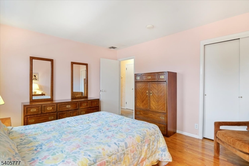 735 Garden Street Union, NJ 07083 - Photo 14 of 29 a bedroom with a bed and wooden floor