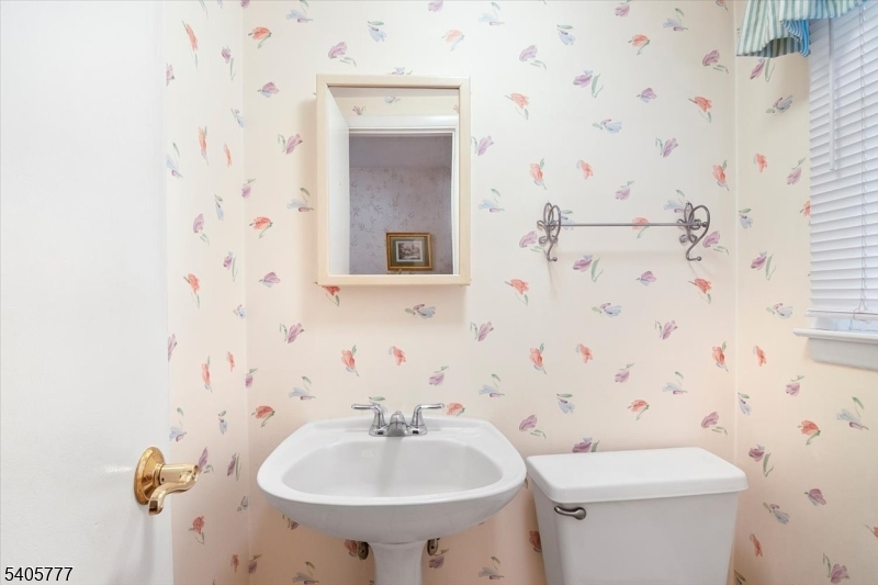 735 Garden Street Union, NJ 07083 - Photo 18 of 29 a bathroom with a sink a toilet and mirror