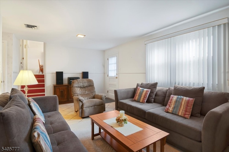 735 Garden Street Union, NJ 07083 - Photo 5 of 29 a living room with furniture and a lamp