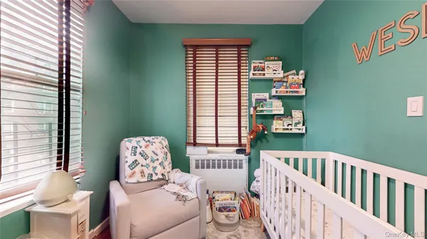 a bedroom with furniture and a window