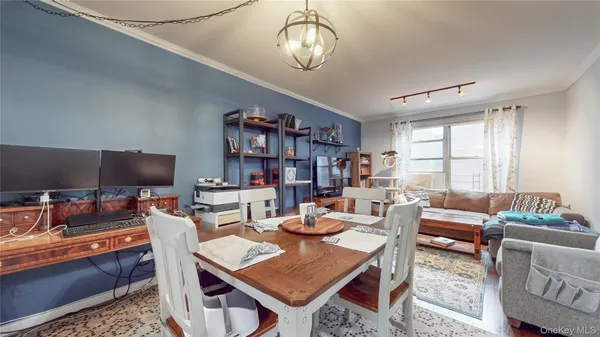 a living room with furniture a flat screen tv and a large window