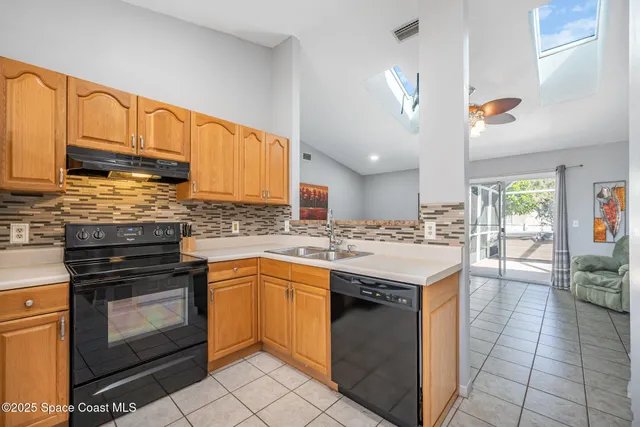 a kitchen with a stove sink and cabinets