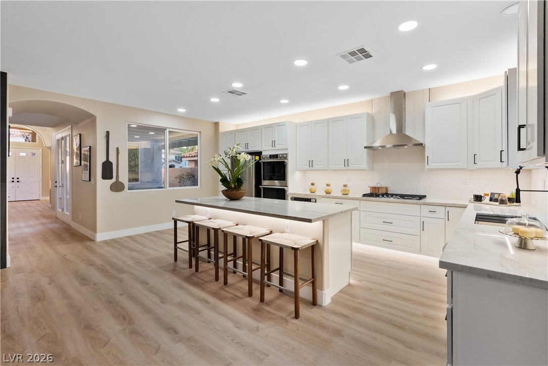 1662 Ravanusa Drive Henderson, NV 89052 - Photo 61 of 74 A chef's kitchen showcasing a large island, stainless steel appliances, and ample cabinetry for culinary excellence.