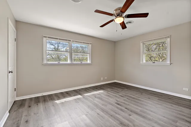 a view of room with hardwood floor and window
