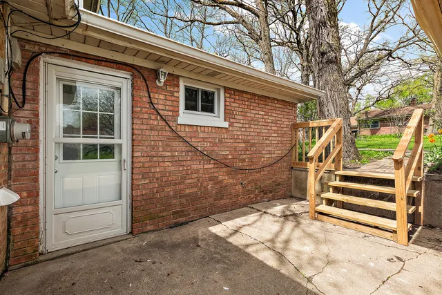 a view of a house with a door and wooden walls