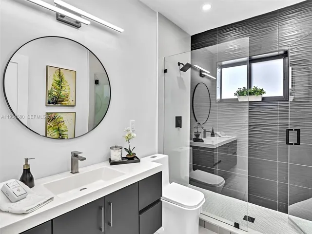 a bathroom with a toilet a sink and mirror