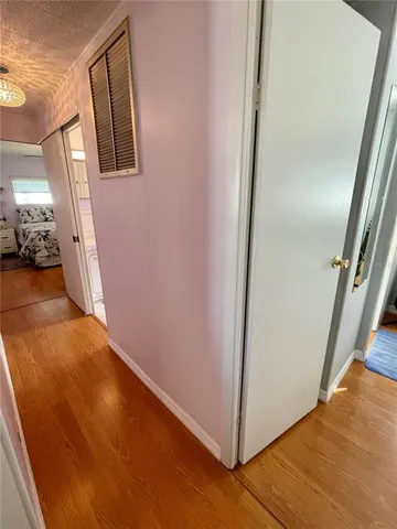 a view of a livingroom with wooden floor and staircase