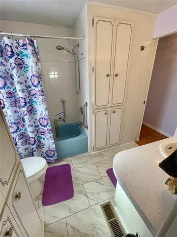 a spacious bathroom with a bathtub and shower