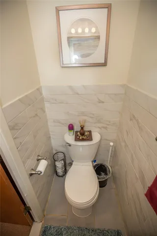 a white toilet sitting next to a bathroom sink