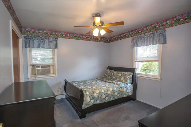 a bedroom with bed and window