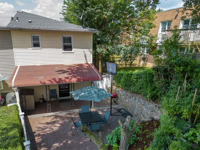 a view of a house with backyard and sitting area