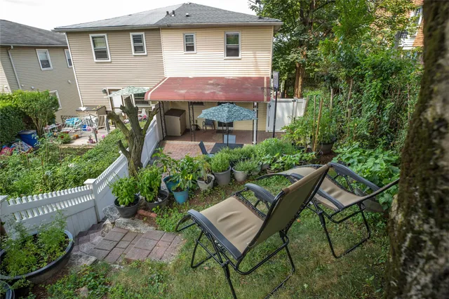 a view of a house with backyard and sitting area