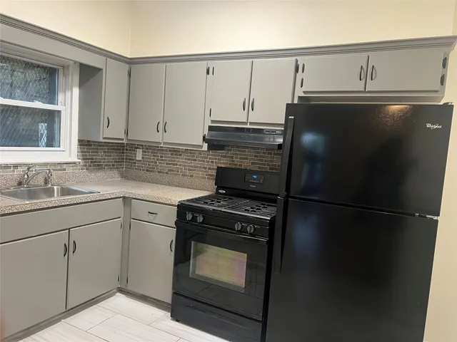 a kitchen with cabinets and appliances