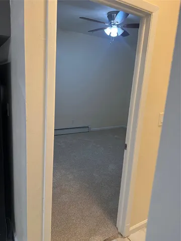 an empty room with a chandelier fan