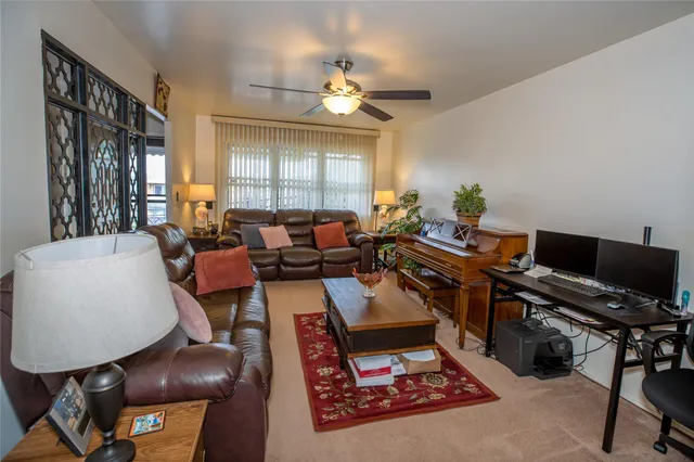 a living room with furniture a chandelier and a window