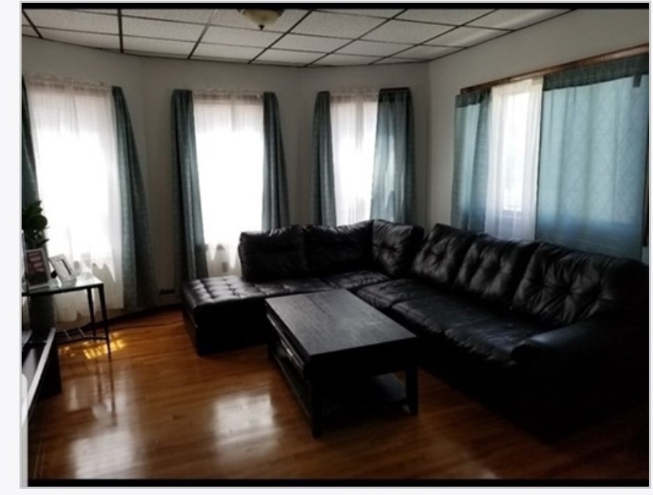 125 Hamilton Street, Unit 2 Worcester, MA 01604 - Photo 8 of 14 a living room with furniture and large windows