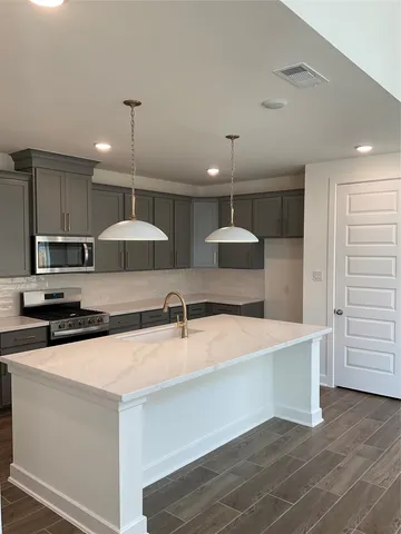 a view of a sink a table and chair in a room