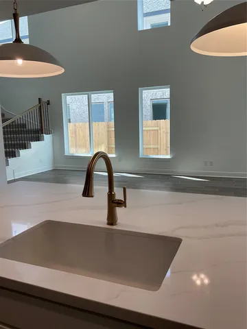 a kitchen with granite countertop a stove and a sink