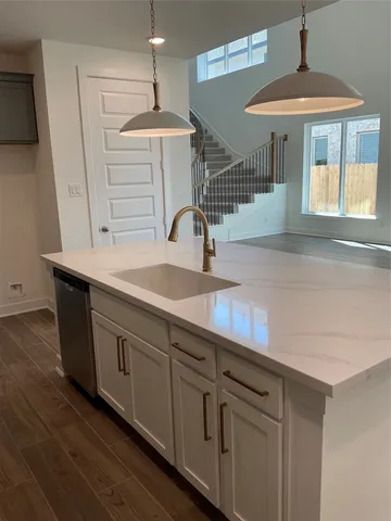 a kitchen with stainless steel appliances a white stove top oven and cabinets