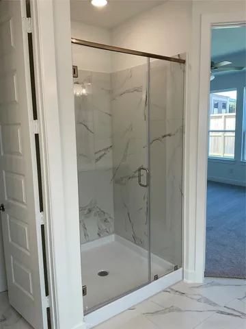 a spacious bathroom with a tub sink and mirror