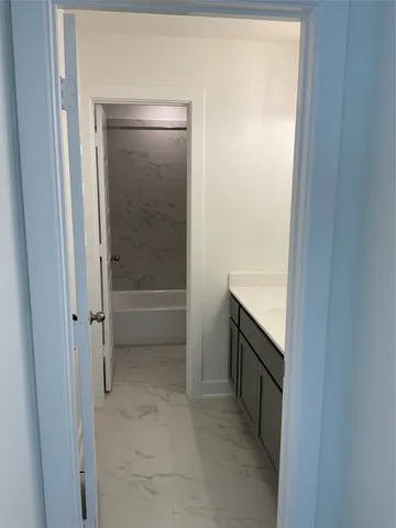 front view of a brick house with a large window