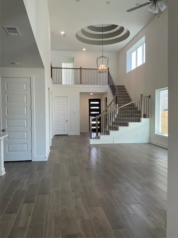 a view of entryway and hall with wooden floor