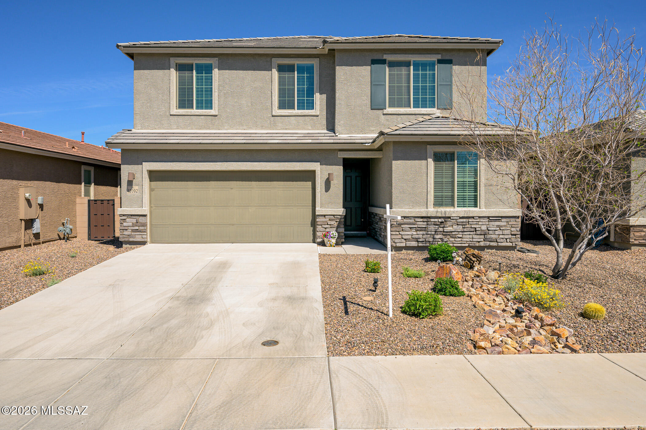 12092 East Ryscott Circle Vail, AZ 85641 - Photo 3 of 49 a front view of a house with a yard