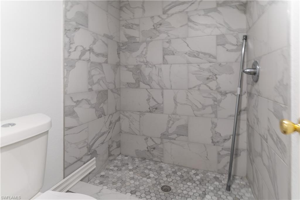 4951 Pepper Circle, Unit A101 Naples, FL 34113 - Photo 11 of 13 a bathroom with a shower
