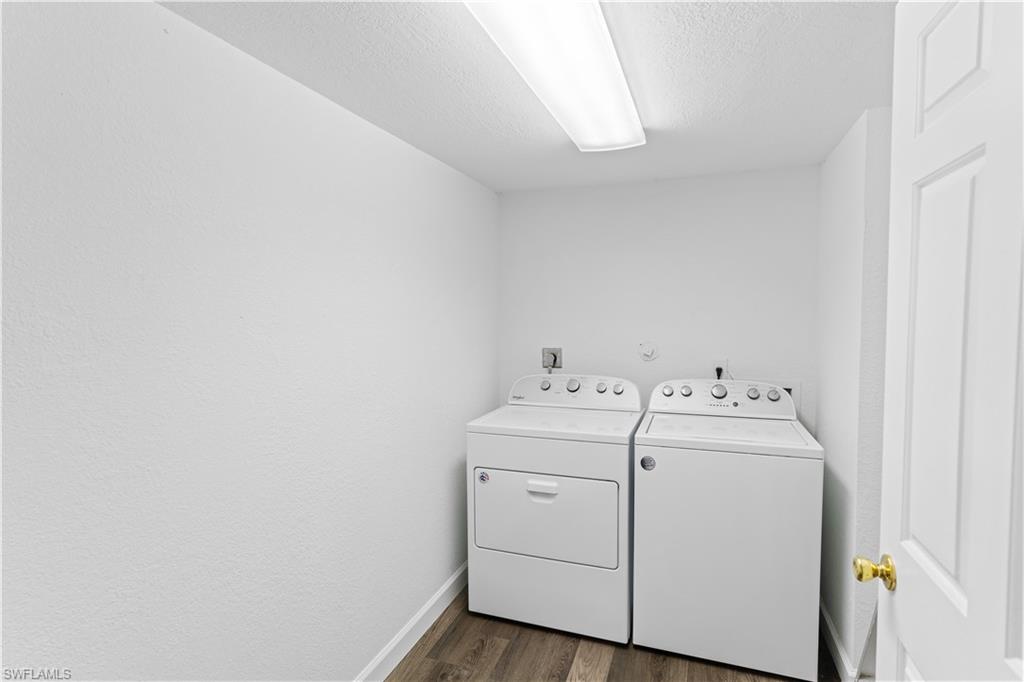 4951 Pepper Circle, Unit A101 Naples, FL 34113 - Photo 10 of 13 a utility room with dryer and washer