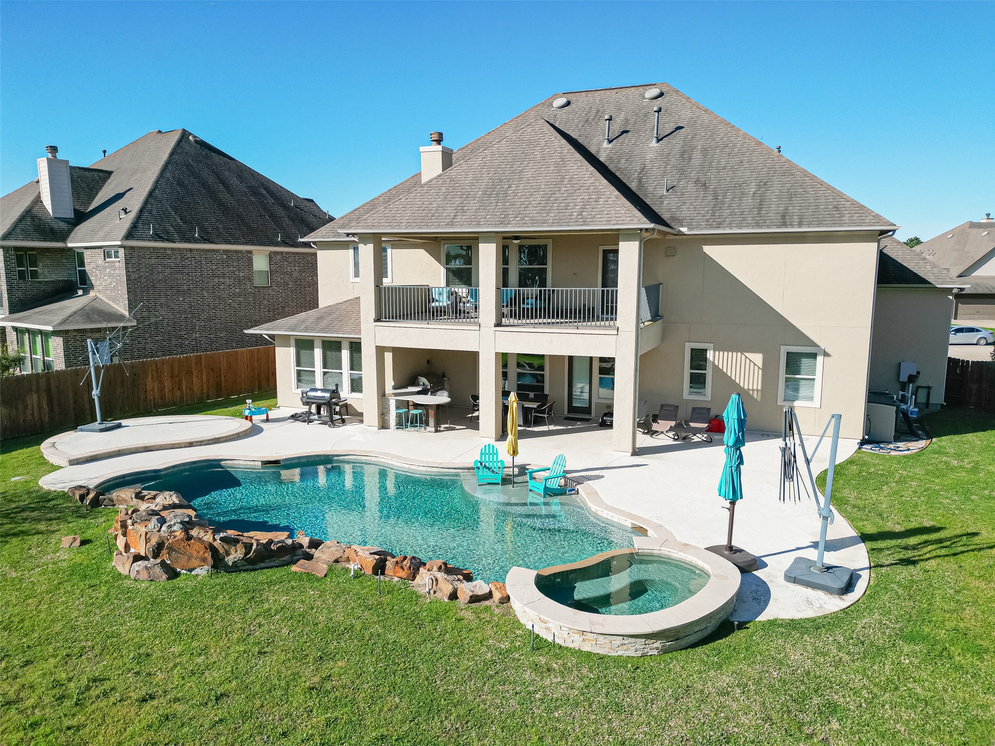 10018 Durango Path Lane Cypress, TX 77433 - Photo 4 of 50 Luxurious backyard oasis with a sparkling pool, spa, and a spacious covered patio—perfect for relaxation and entertaining.