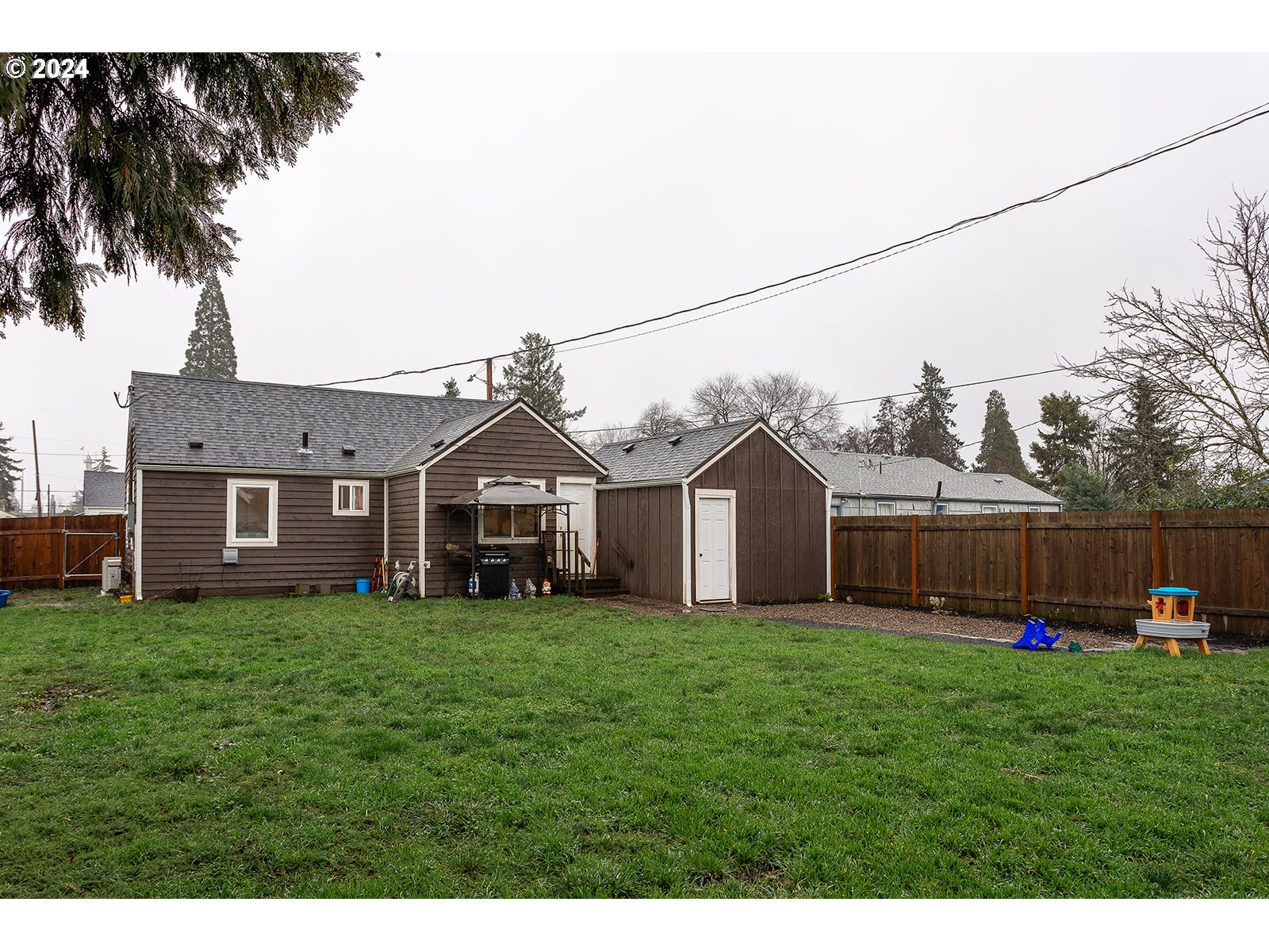370 25th Street Springfield, OR 97477 - Photo 15 of 16 a front view of a house with a yard and palm trees