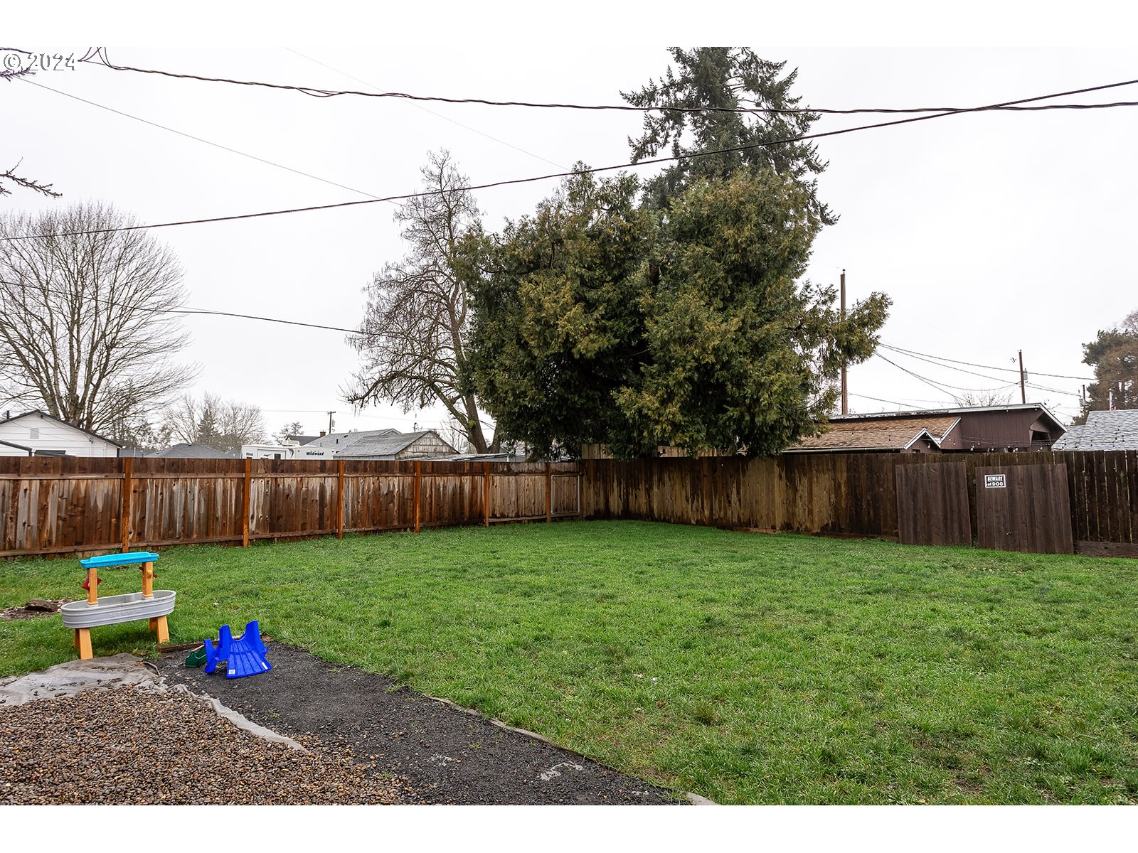 370 25th Street Springfield, OR 97477 - Photo 16 of 16 a view of a yard with potted plants and wooden fence