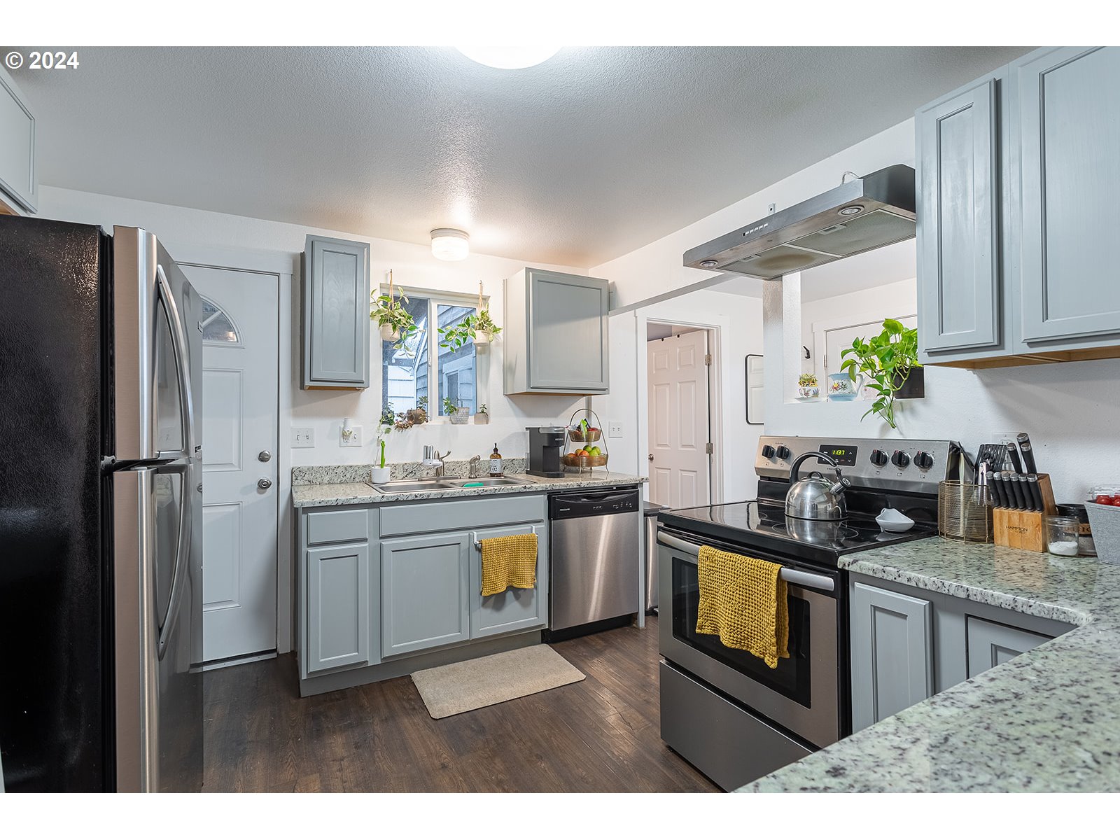 370 25th Street Springfield, OR 97477 - Photo 5 of 16 a kitchen with stainless steel appliances granite countertop a refrigerator sink and stove