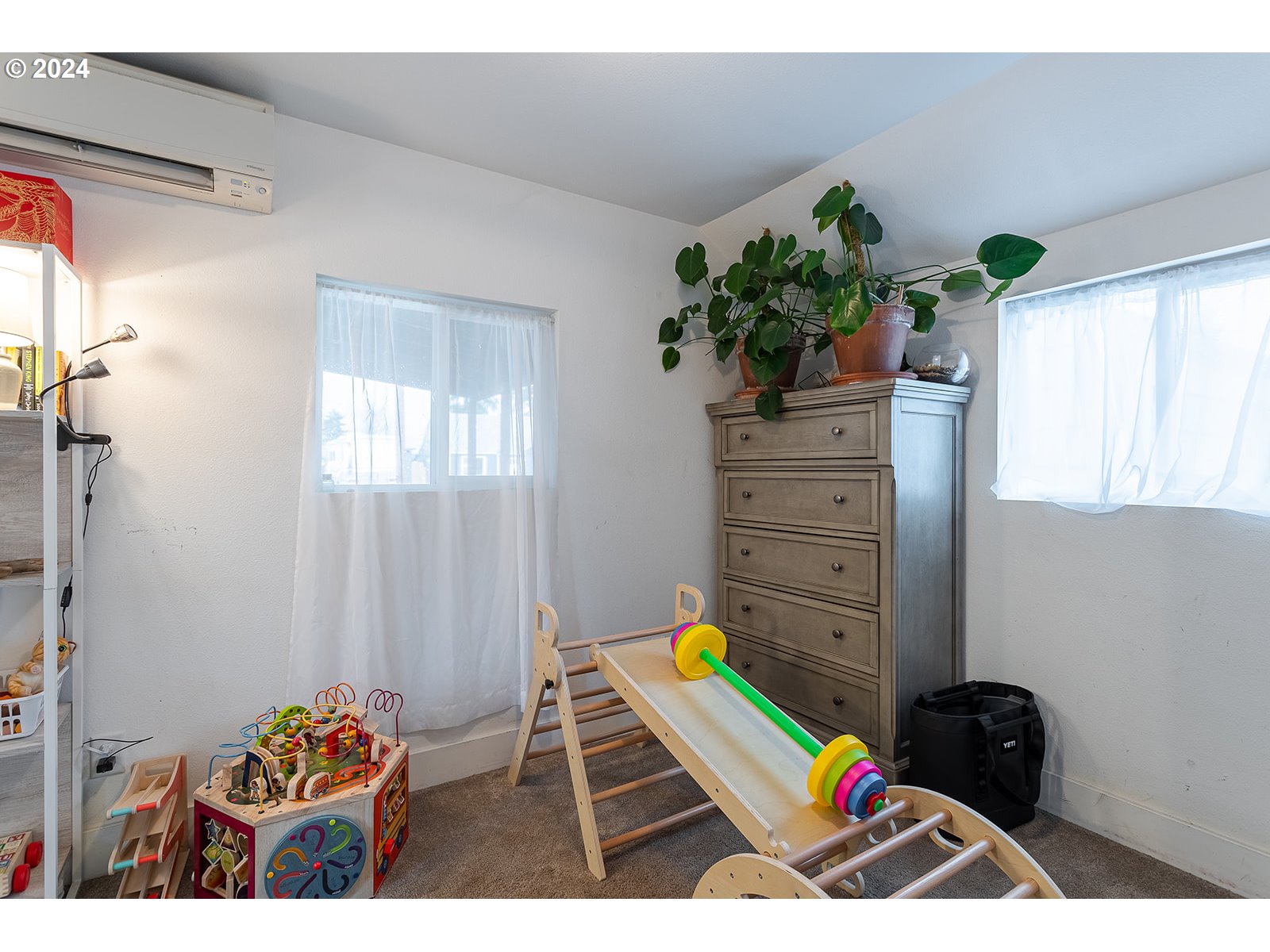 370 25th Street Springfield, OR 97477 - Photo 8 of 16 a room with painting on the wall and a potted plant