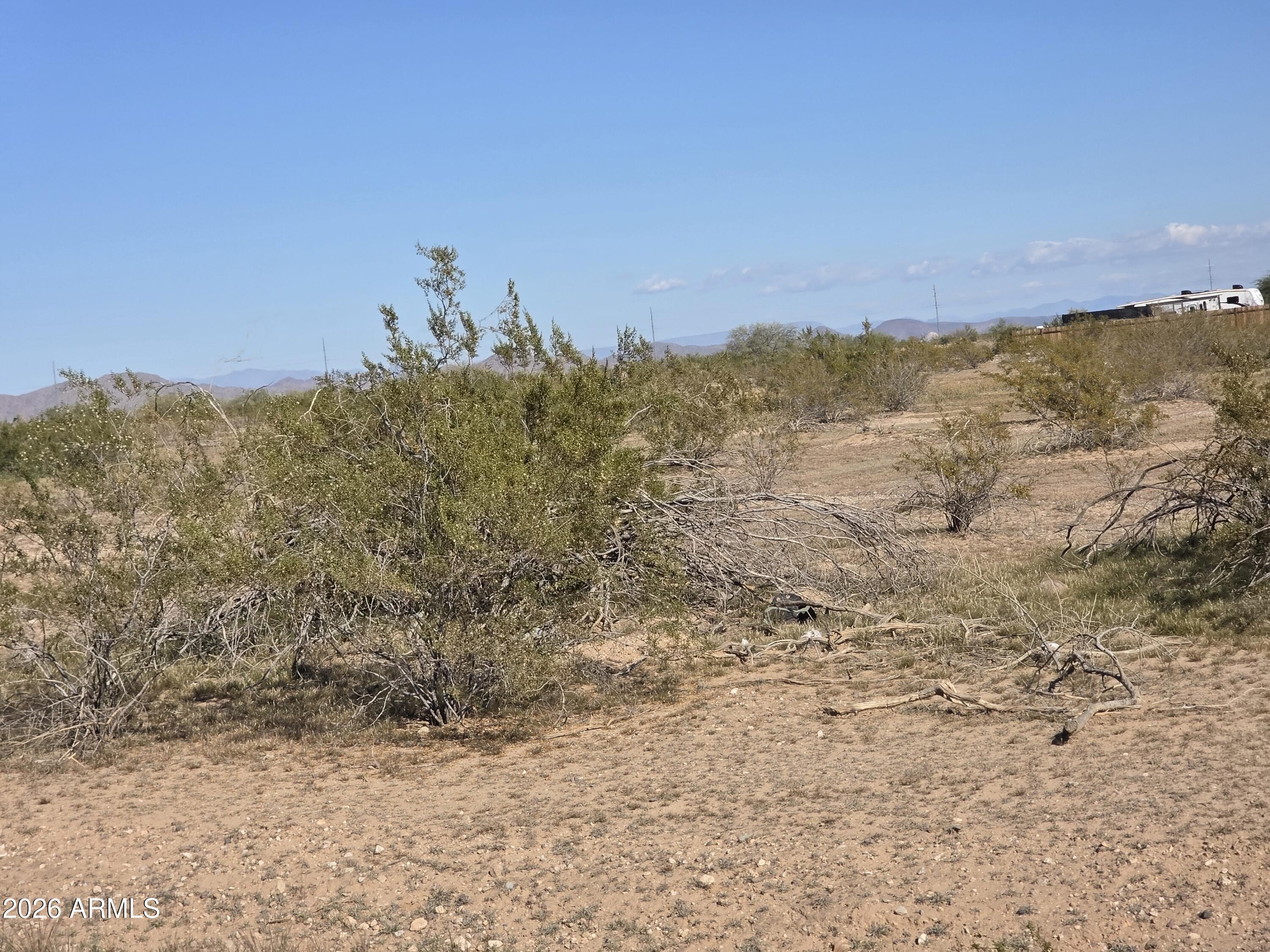 19300 West Roadrunner Road Wittmann, AZ 85361 - Photo 30 of 102 a view of a dry yard with mountains in the background