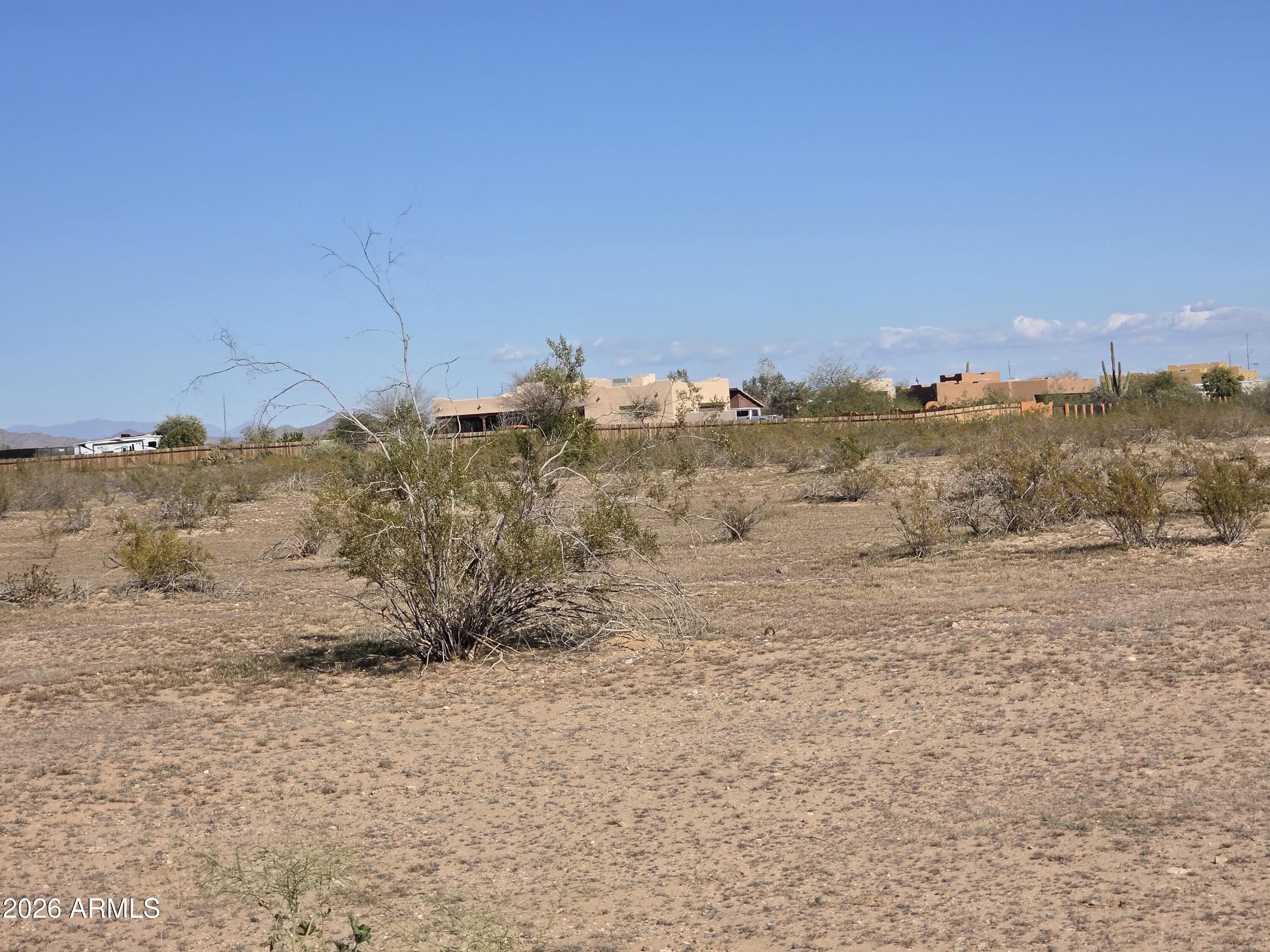 19300 West Roadrunner Road Wittmann, AZ 85361 - Photo 35 of 102 a view of a dry yard with mountains in the background