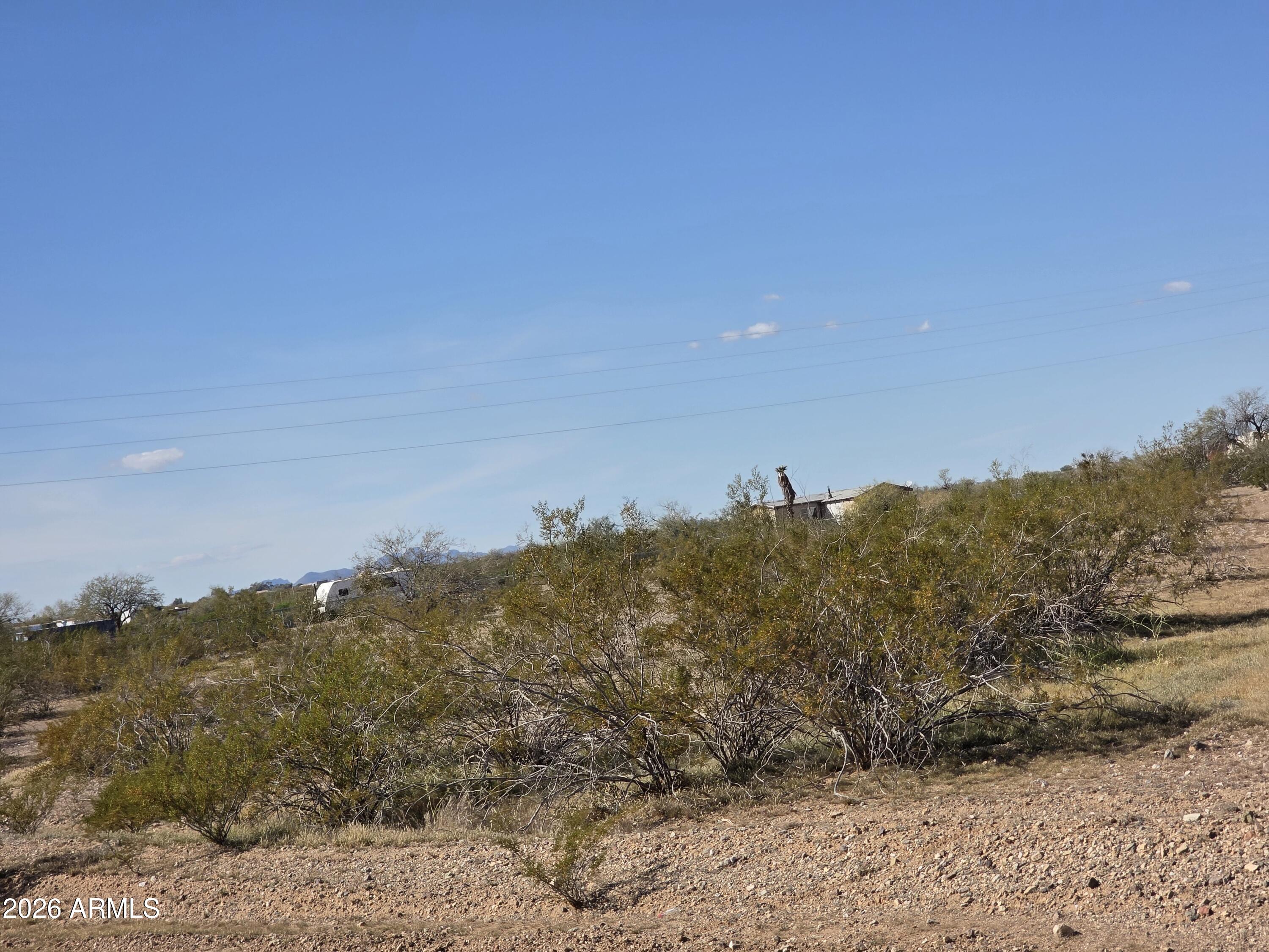19300 West Roadrunner Road Wittmann, AZ 85361 - Photo 47 of 102 a view of a dry yard with mountains in back