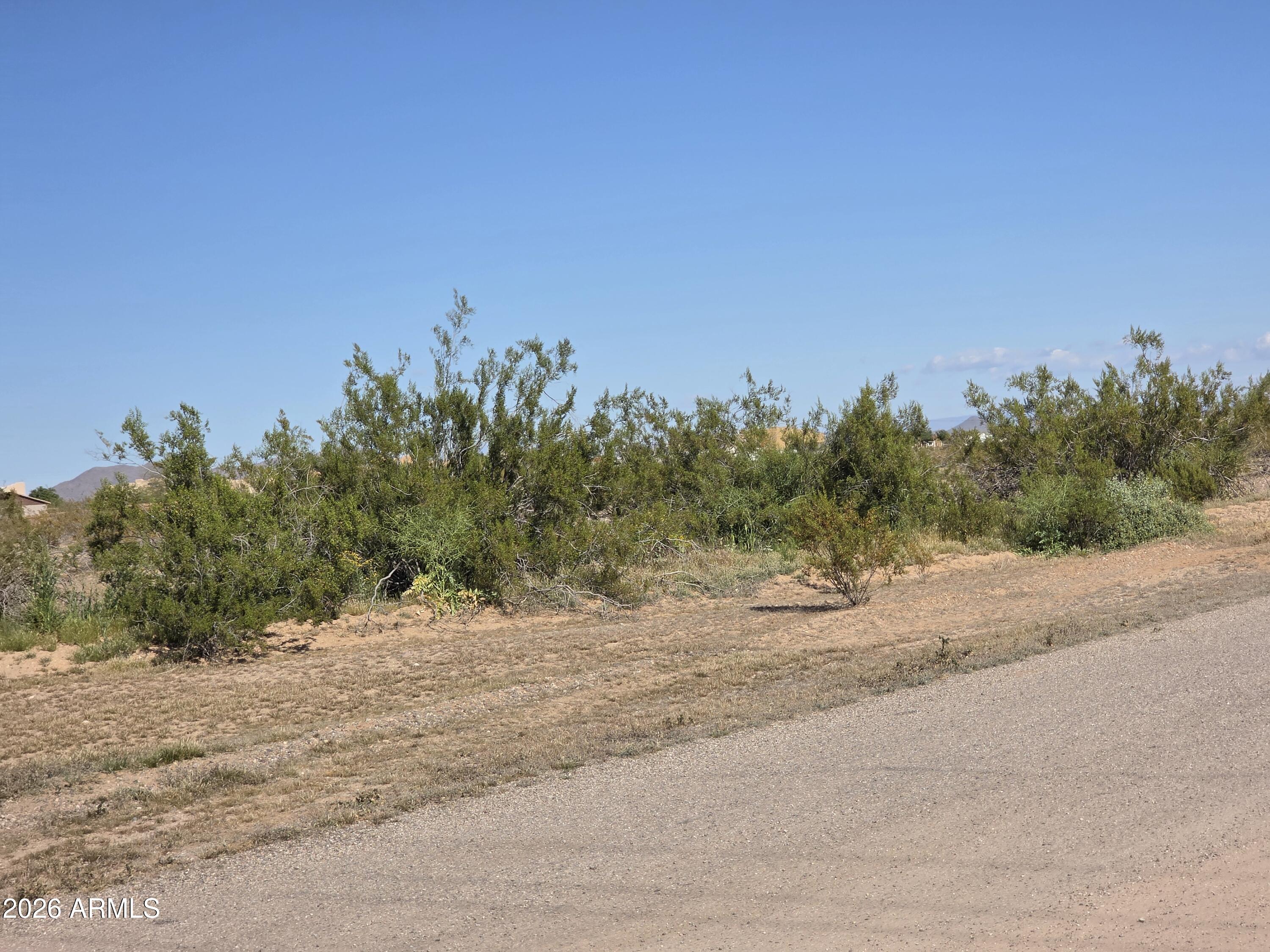 19300 West Roadrunner Road Wittmann, AZ 85361 - Photo 64 of 102 a view of a road with a building in the background