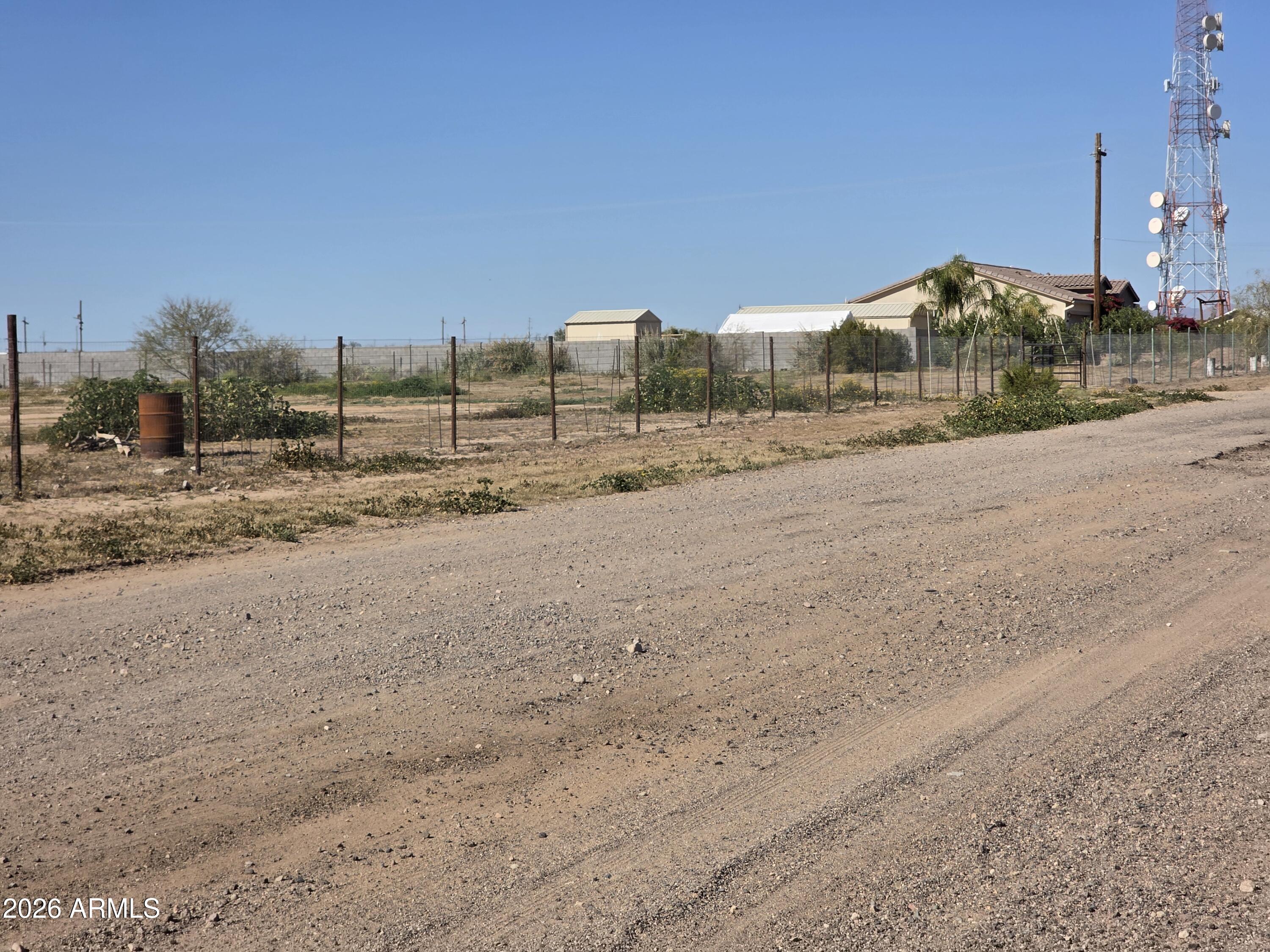 19300 West Roadrunner Road Wittmann, AZ 85361 - Photo 72 of 102 a view of a dirt road with a building in the background
